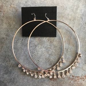 Large gold hoop earrings with dangling jewelry